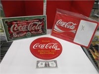 Three Coca-Cola signs