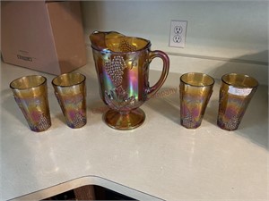 Carnival glass water pitcher and tumblers
