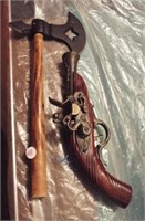 Hatchet and replica flint lock gun. Gun measures