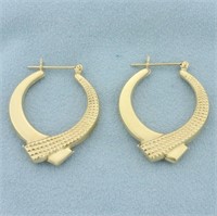 Crossover Ribbon Design Hoop Earrings in 14k Yello