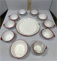 Nine red and white enamel ware mugs, pie plate,