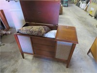 Old  stereo cabinet w / pillows & bedding inside