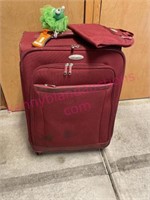 Red Samsonite spinning suitcase