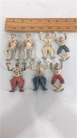 Lot of 7 cast iron toy soldiers and clowns.