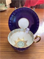 Aynsley flow blue and starburst cup and saucer