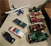 Cars and air plane. 1 Model A's, 1 Cadillac, 1
