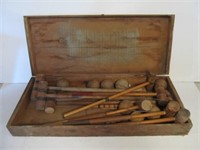 Croquet game with hinged lid in old wood case.