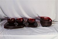 Set of ruby red plates, bowls, cups, and saucers