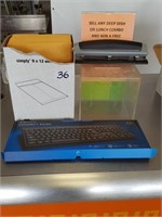 assorted office supplies and new keyboard
