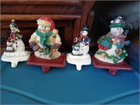 Four vintage cast iron Snowman stocking holders