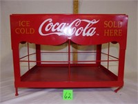 metal coke sold here case (legs bent)