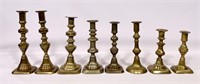 8 brass candlesticks, some have pushups (some