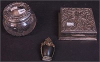 A silver box decorated with elephants marked