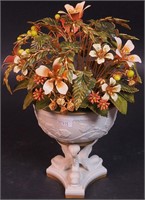 A 10" bisque urn with fish-leg stand filled