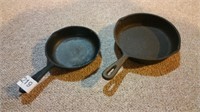 Two smaller diameter cast iron skillets