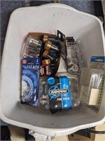 Bin with assortment of batteries and light bulbs
