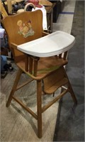 Vintage wooden child’s high chair with plastic