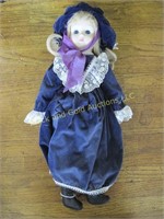 Bisque head doll in faded purple outfit