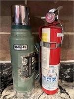 Lot of Stanley thermos and fire extinguisher.
