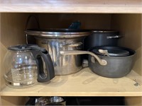 Lot of crockpot, pots and pans.