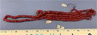 Lot of old cranberry colored trade beads of variou