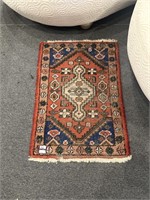 Small orange and blue scatter rug