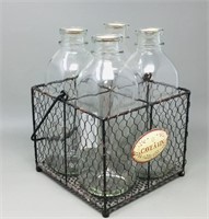 4 milk bottles in wire basket w /  handle