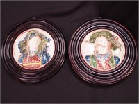 Pair of majolica wall plaques of woman and man in
