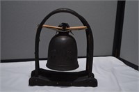 Vintage bell on wooden stand w/ hide