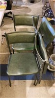 Set of four vintage dark green foldable chairs.