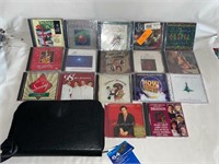 17) CHRISTMAS CDs AND 64 CAPACITY CD/DVD CASE