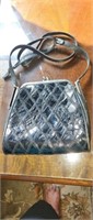 Black snake skin purse with small tear on left