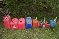 9 plastic fuel cans of various sizes; as is