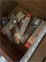 Rose stainless spoons, new in box. (8) spoons and