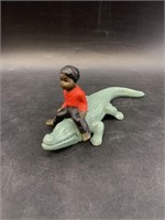 Cast iron child riding an alligator