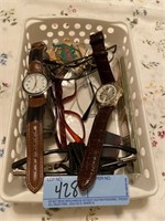 Basket with watches, glasses, flashlight