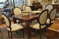 Eight wood and linen upholstered dining chairs