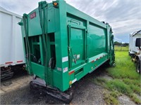 Green Trash Compactor From Garbage Truck