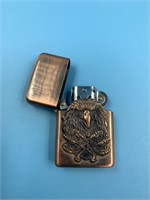 Copper lighter with a bird on front
