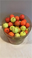 E2) 100 golf balls yellow and orange, used, mostly