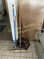 Assortment of brooms and other items