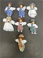 7 small porcelain dolls