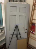 Two wooden doors and a tripod.