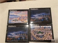 4 NEW IN BOX PUZZLES BY NOVAKOWSKI 12X18