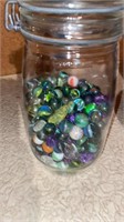 Glass jar of marbles 9 inches tall