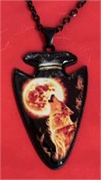 Arrowhead necklace wolf howling at a fiery moon,