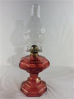 Vintage oil lamp with red glass bottom