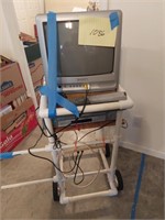 TV and VCR on homemade roll around stand -