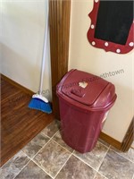 Broom and plastic trashcan