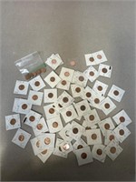 Assortment of Pennies, most in protective casings